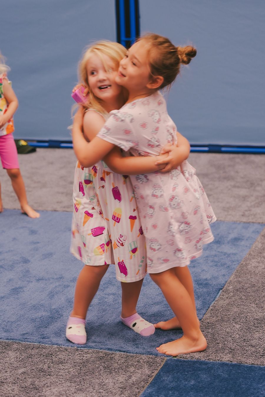 Two little girls hugging in the kids room