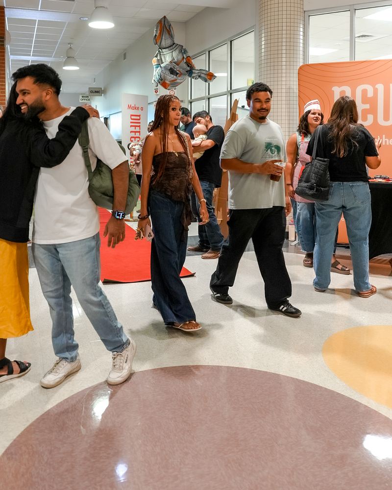 People walking through the lobby on a Sunday, mid-stride