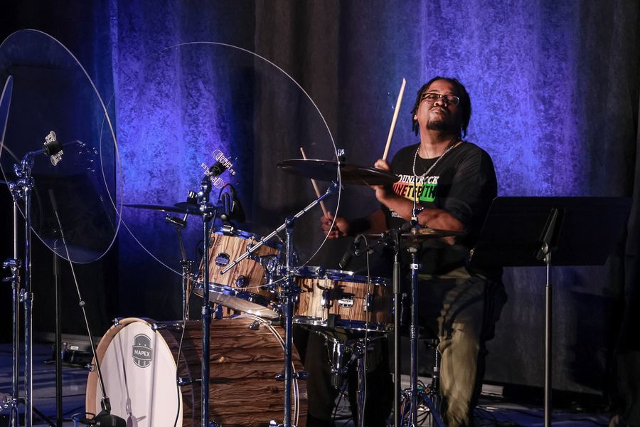The drummer playing on stage
