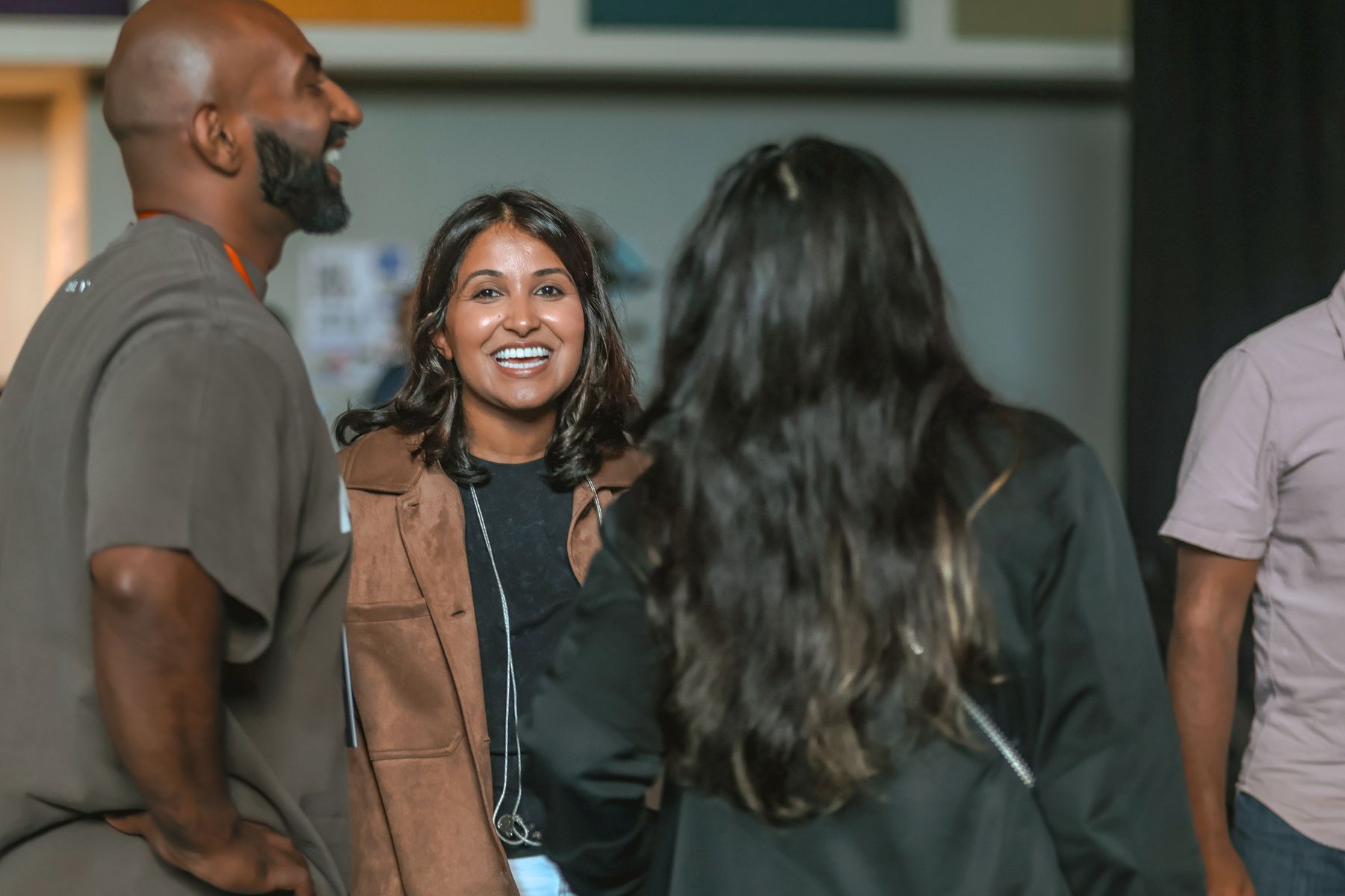 A woman smiling in the middle of a conversation after a service